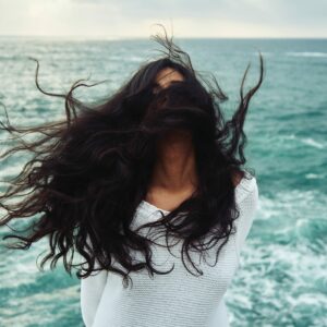 Gesichtspflege_Frau mit langen Haaren am Meer